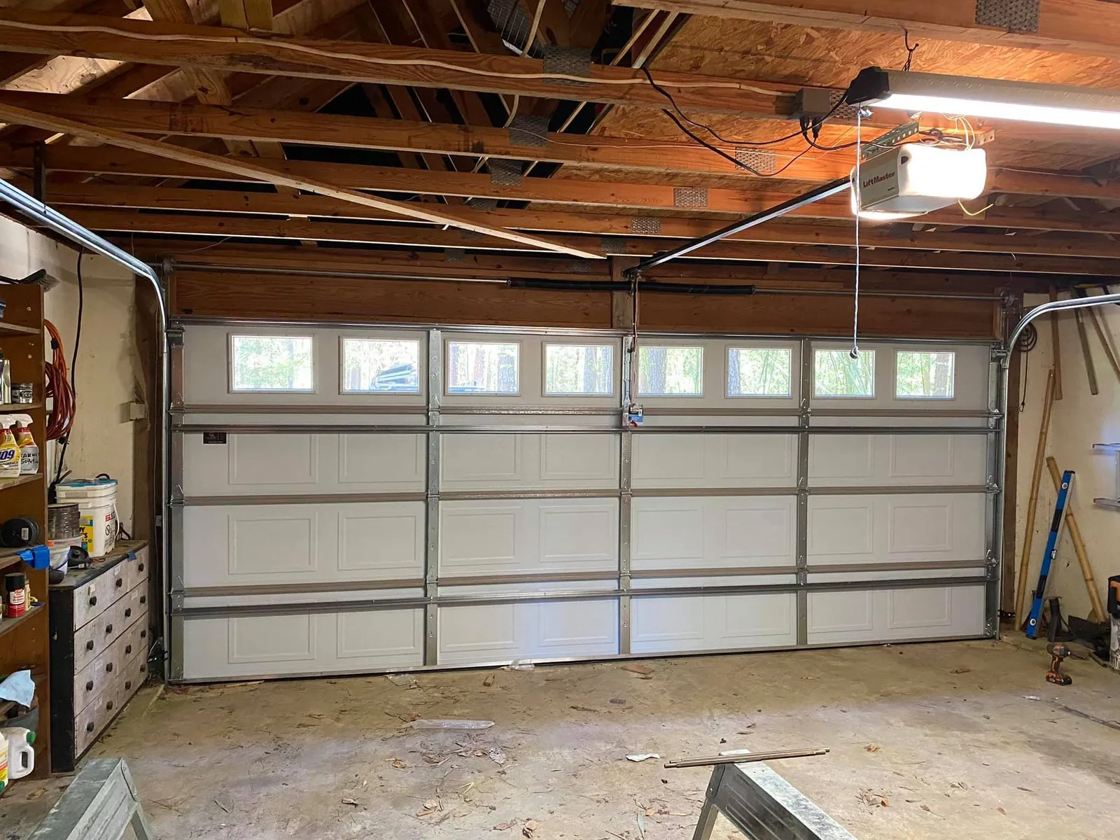 Interior of a converted carport garage with a new door