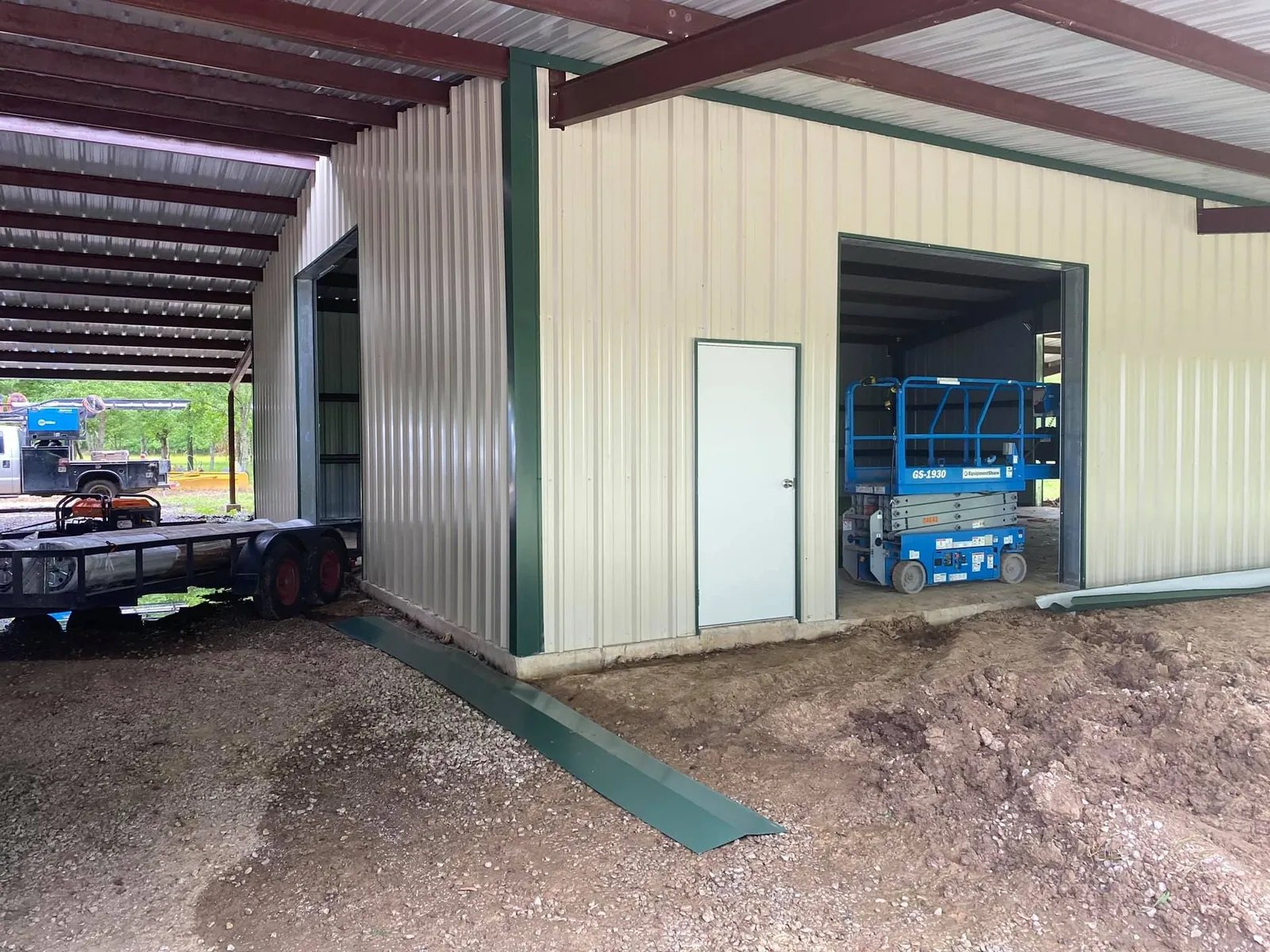 Metal building with commercial garage doors and an open bay