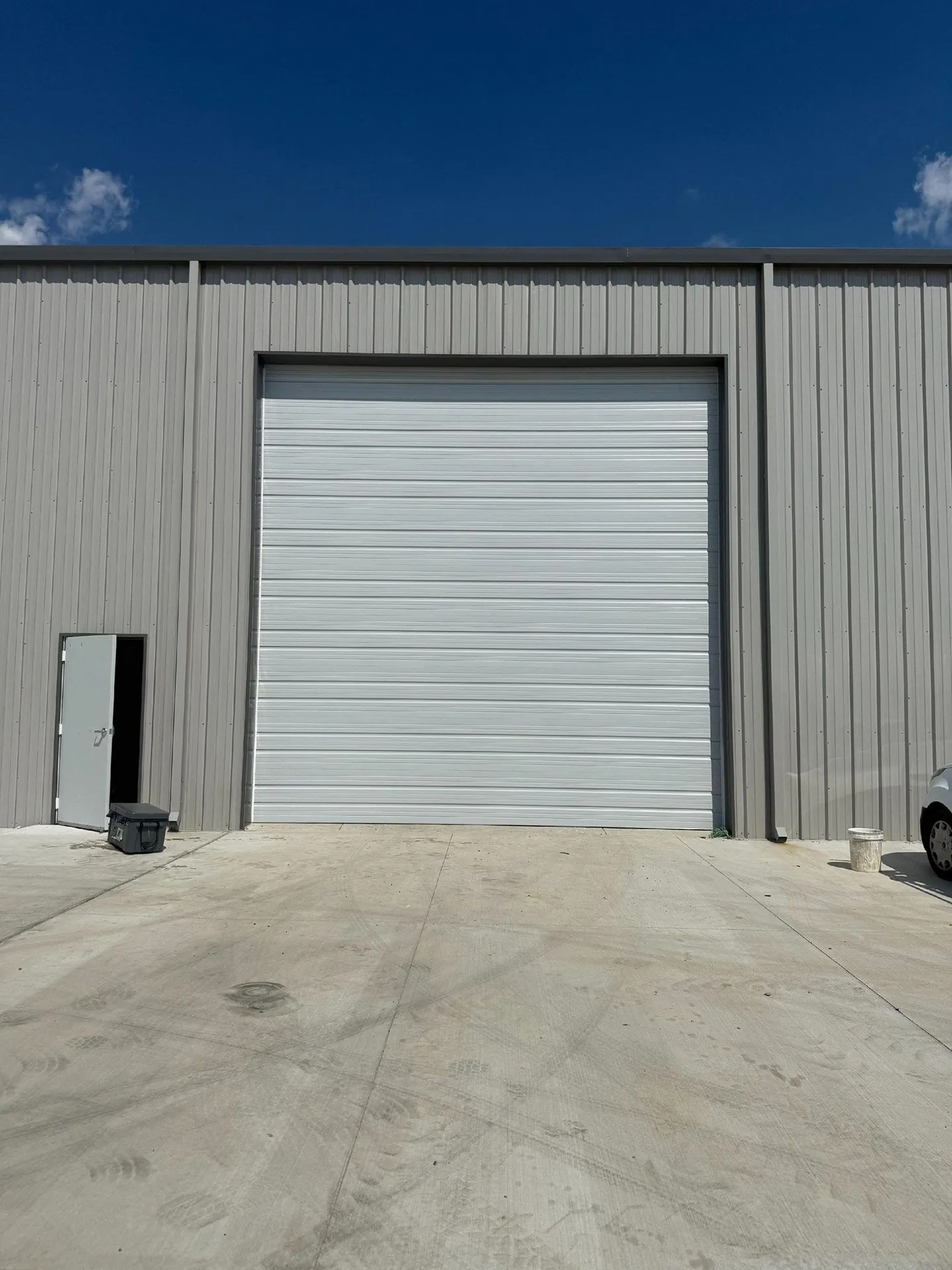 White roll-up door on a commercial metal building