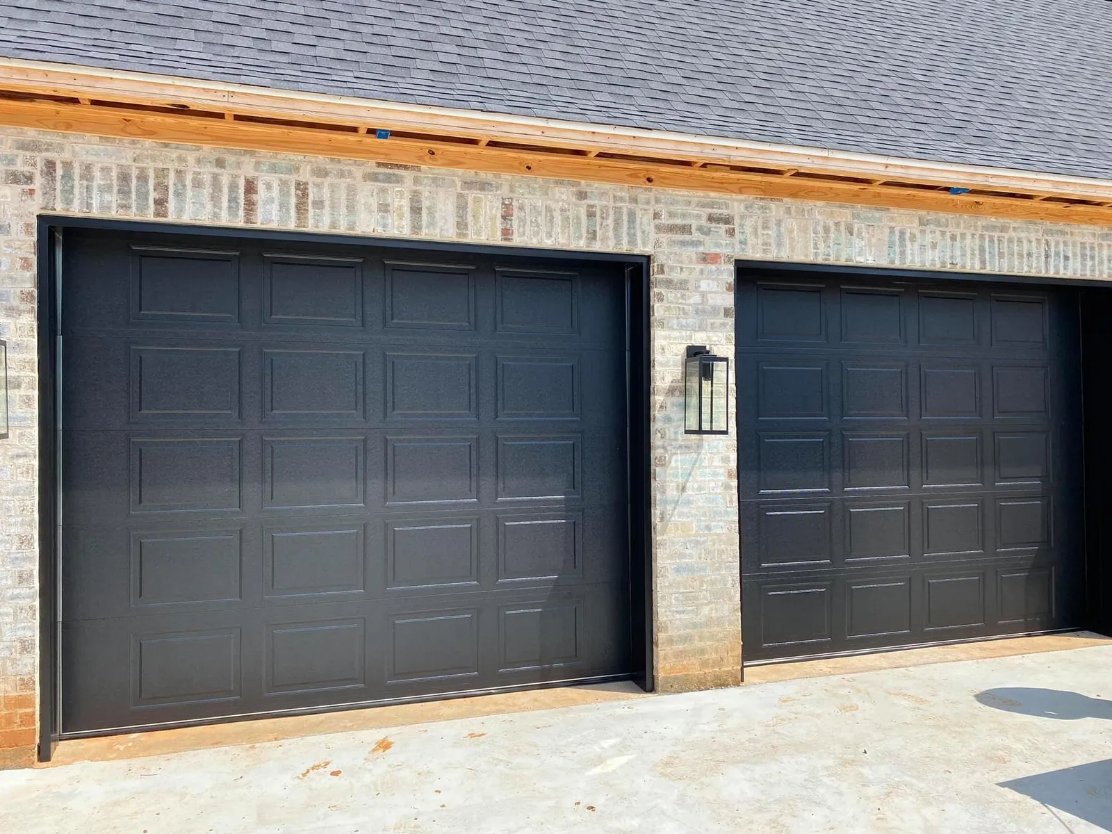 Black garage doors installed by Geaux Overhead Door
