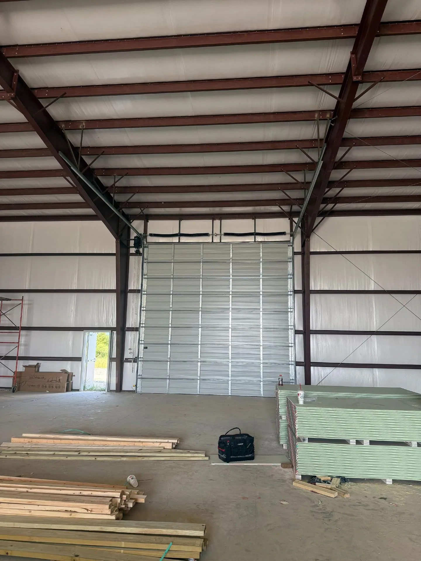 Interior of a metal building with an open garage door bay