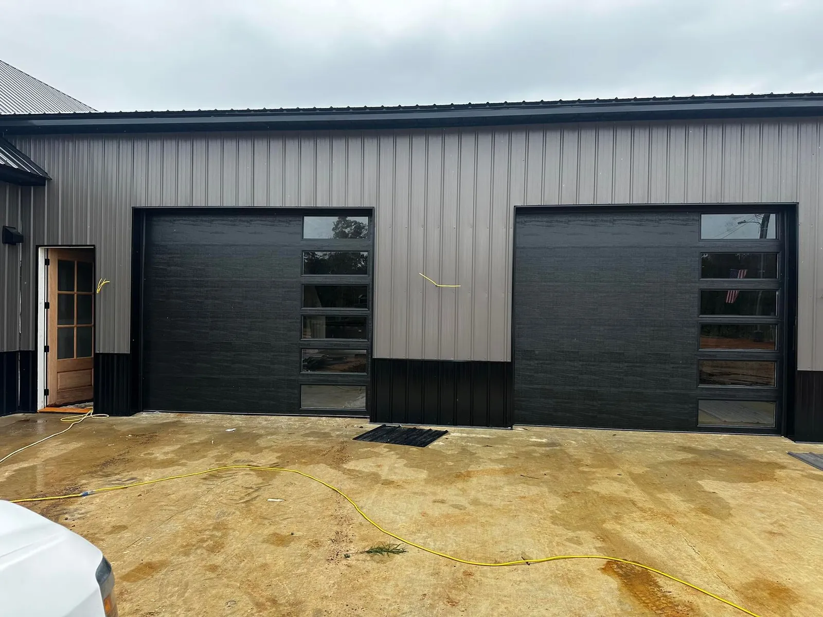 Full-view black glass garage doors on a home