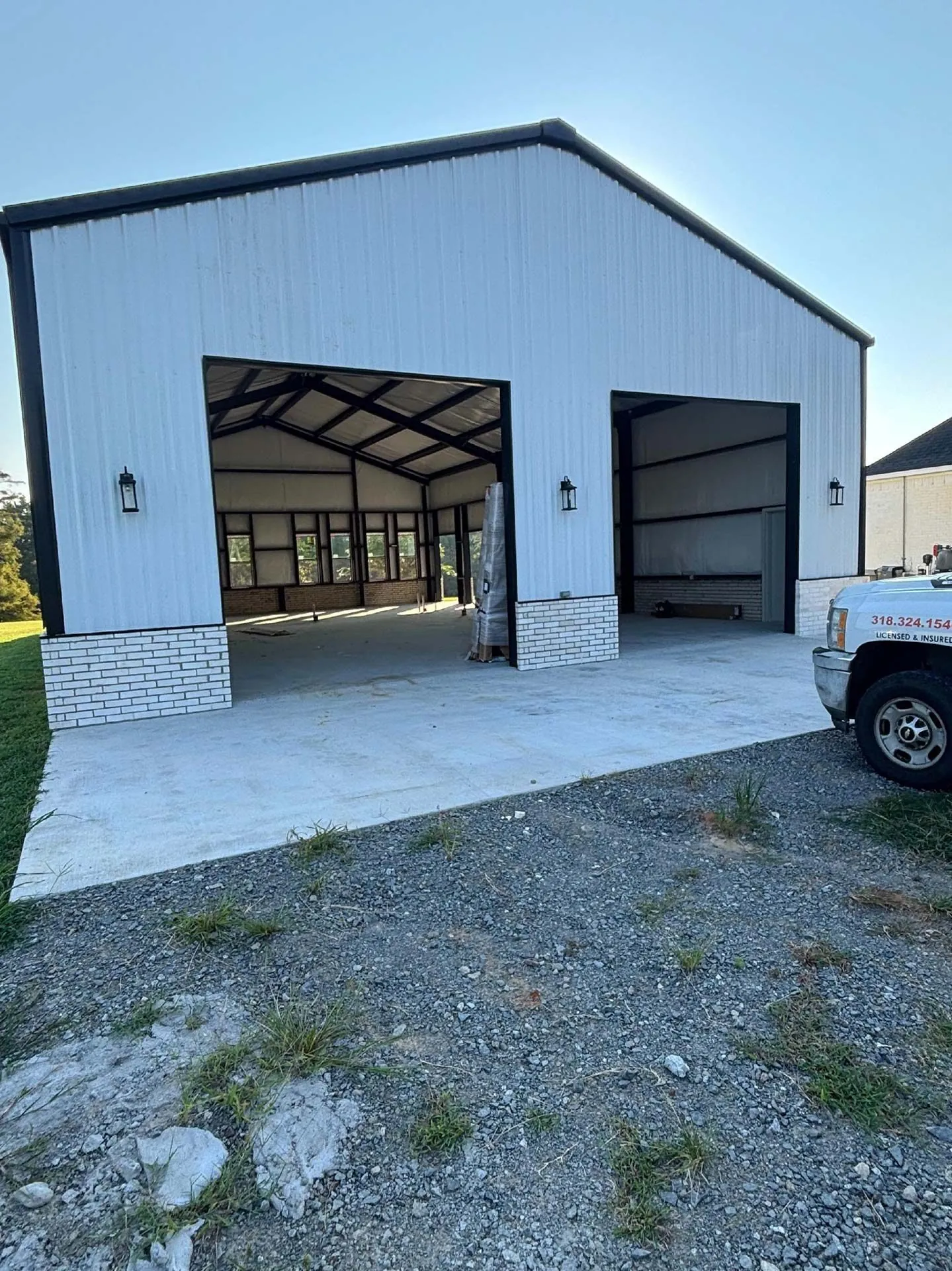 White garage door on a metal building after maintenance