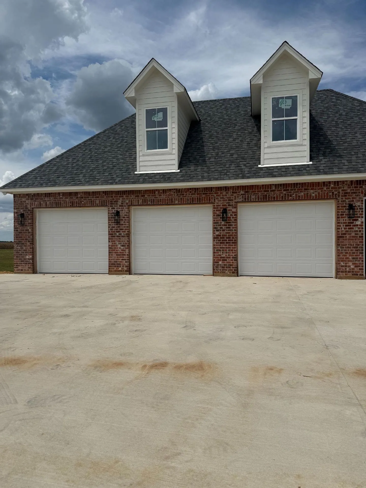Two white doors on a home with dormers