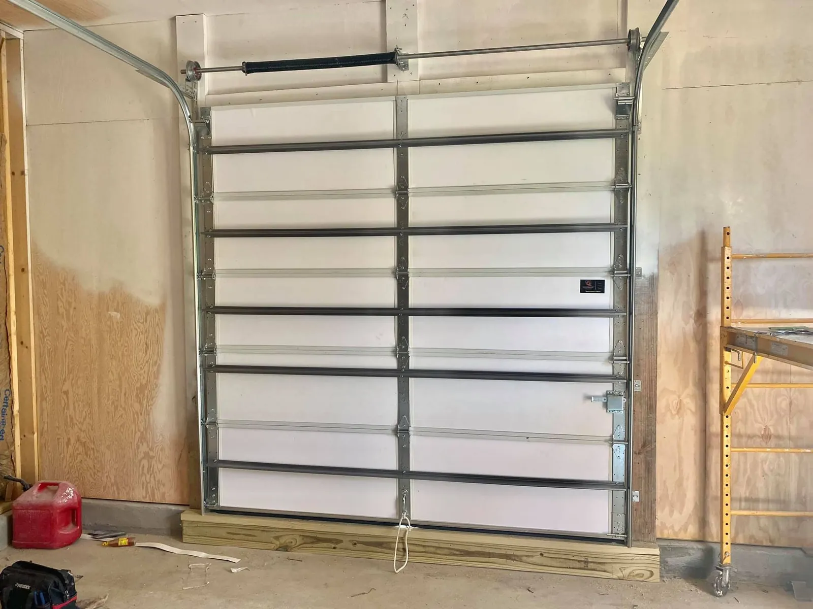 Interior view of a garage door with torsion spring assembly