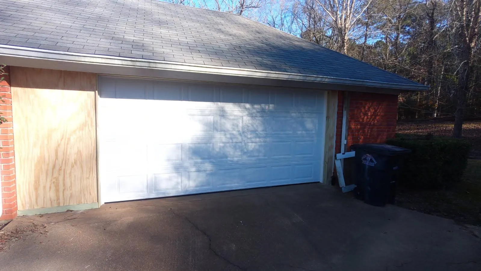 Wide white garage door installed on a home in the Geaux Overhead Door service area
